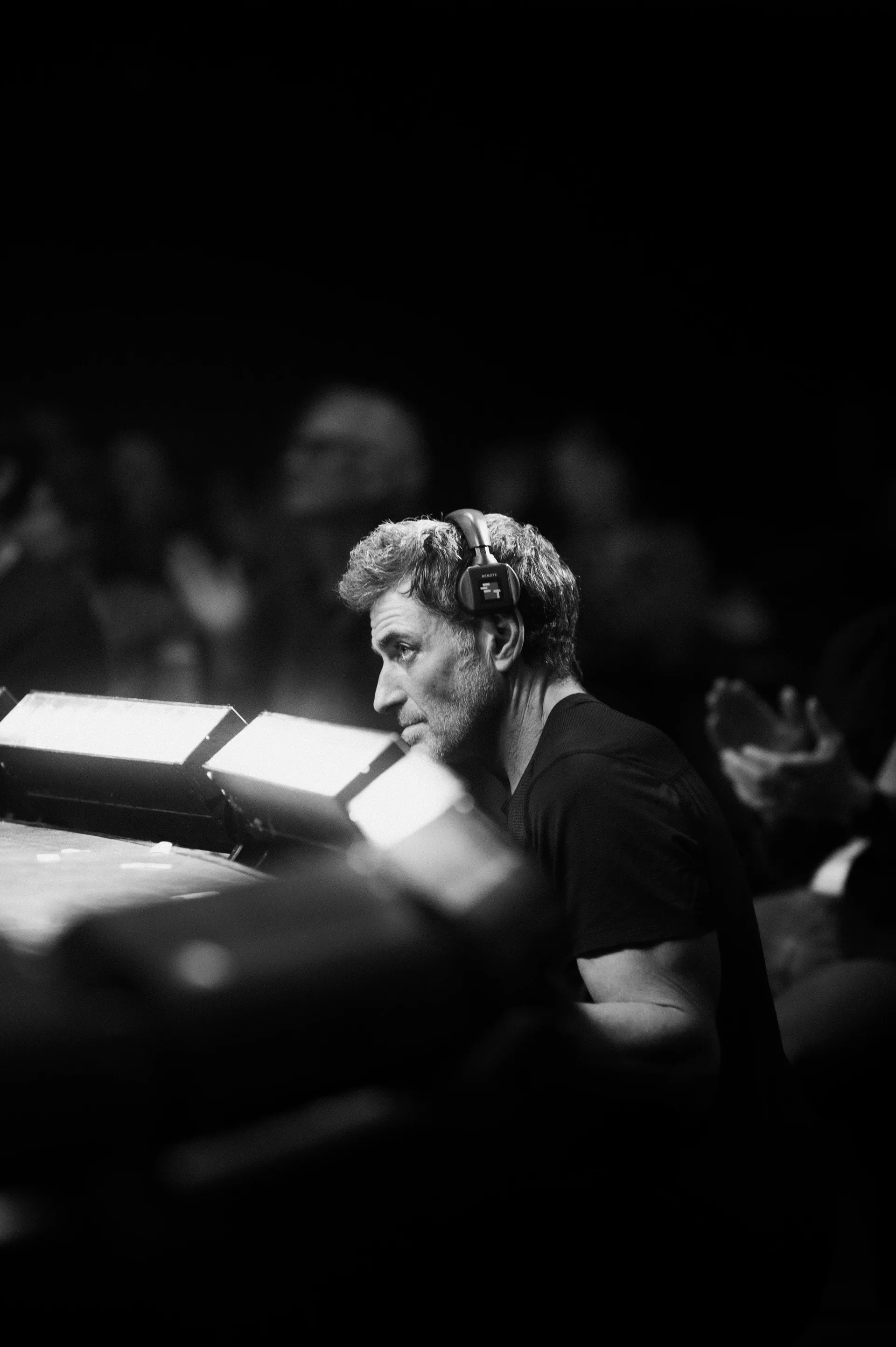 Musician sits at a keyboard with illuminated sheet music.