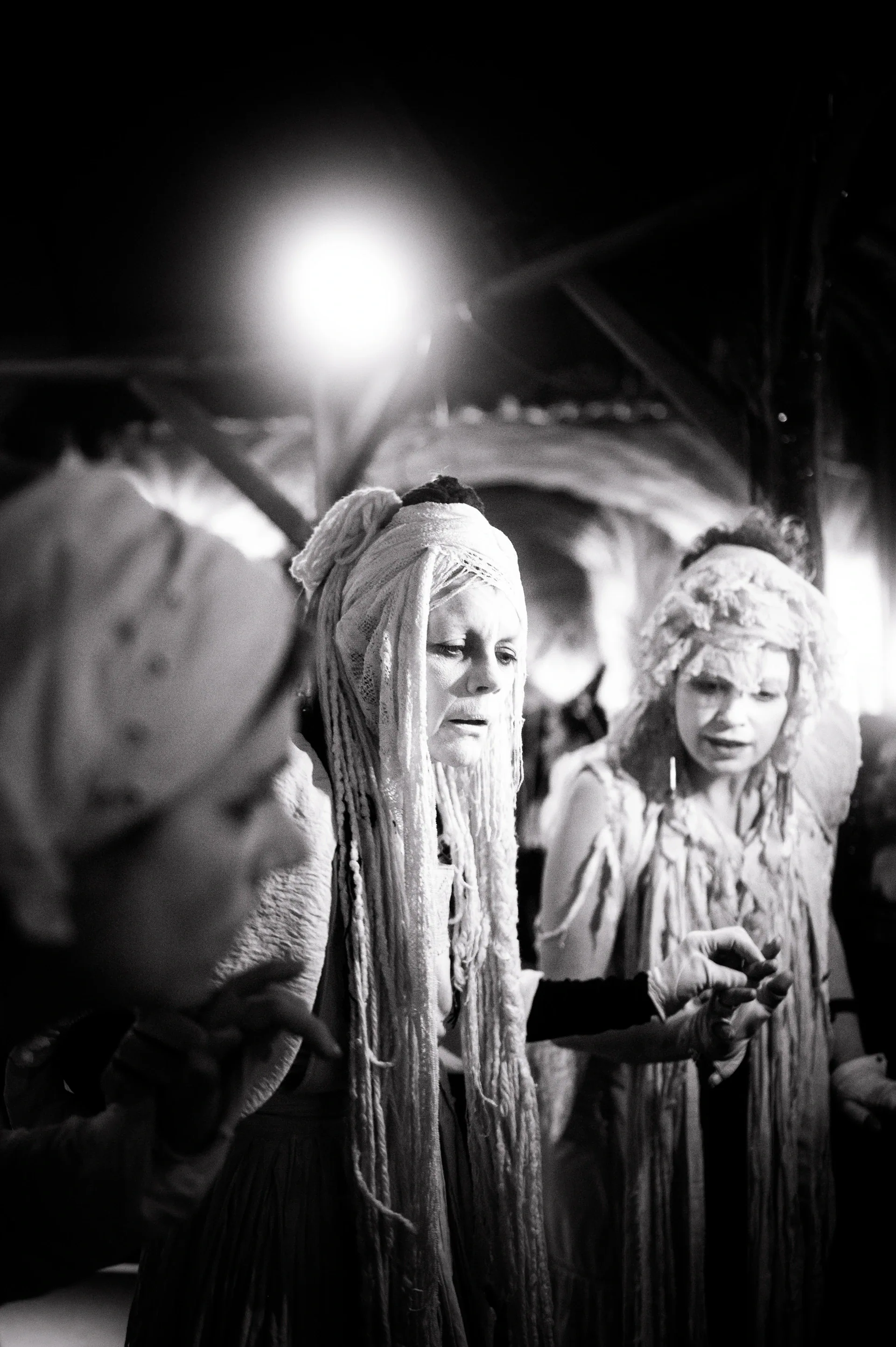 Two costumed attendees with long pale hair look toward the camera.