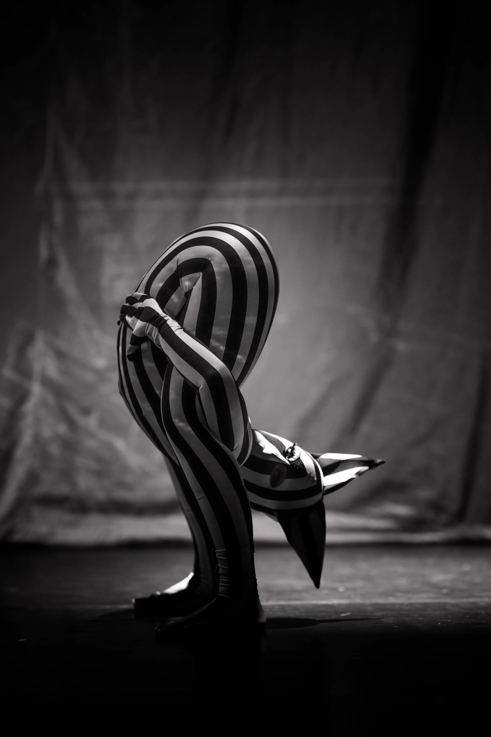 Striped sculptural chair stands alone on the stage.