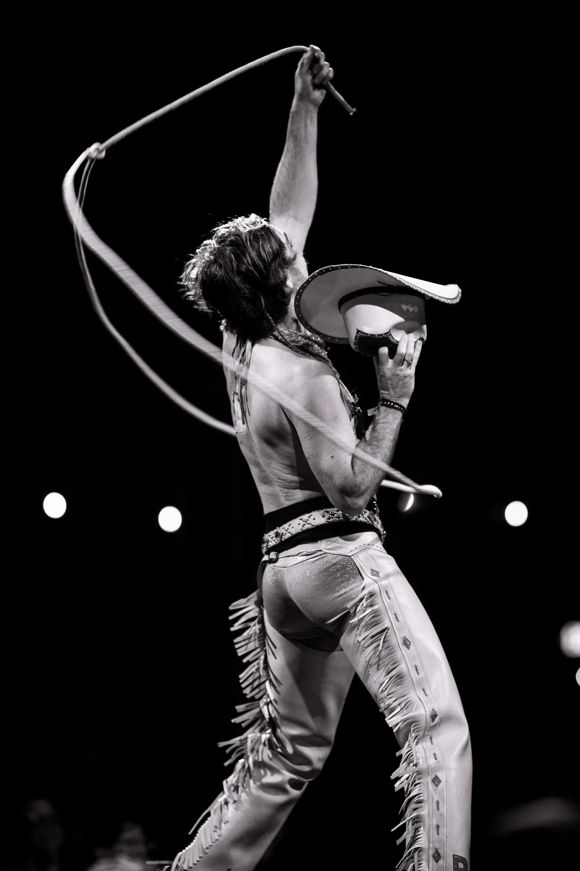 Two performers face each other while one reaches toward the other's shoulder.