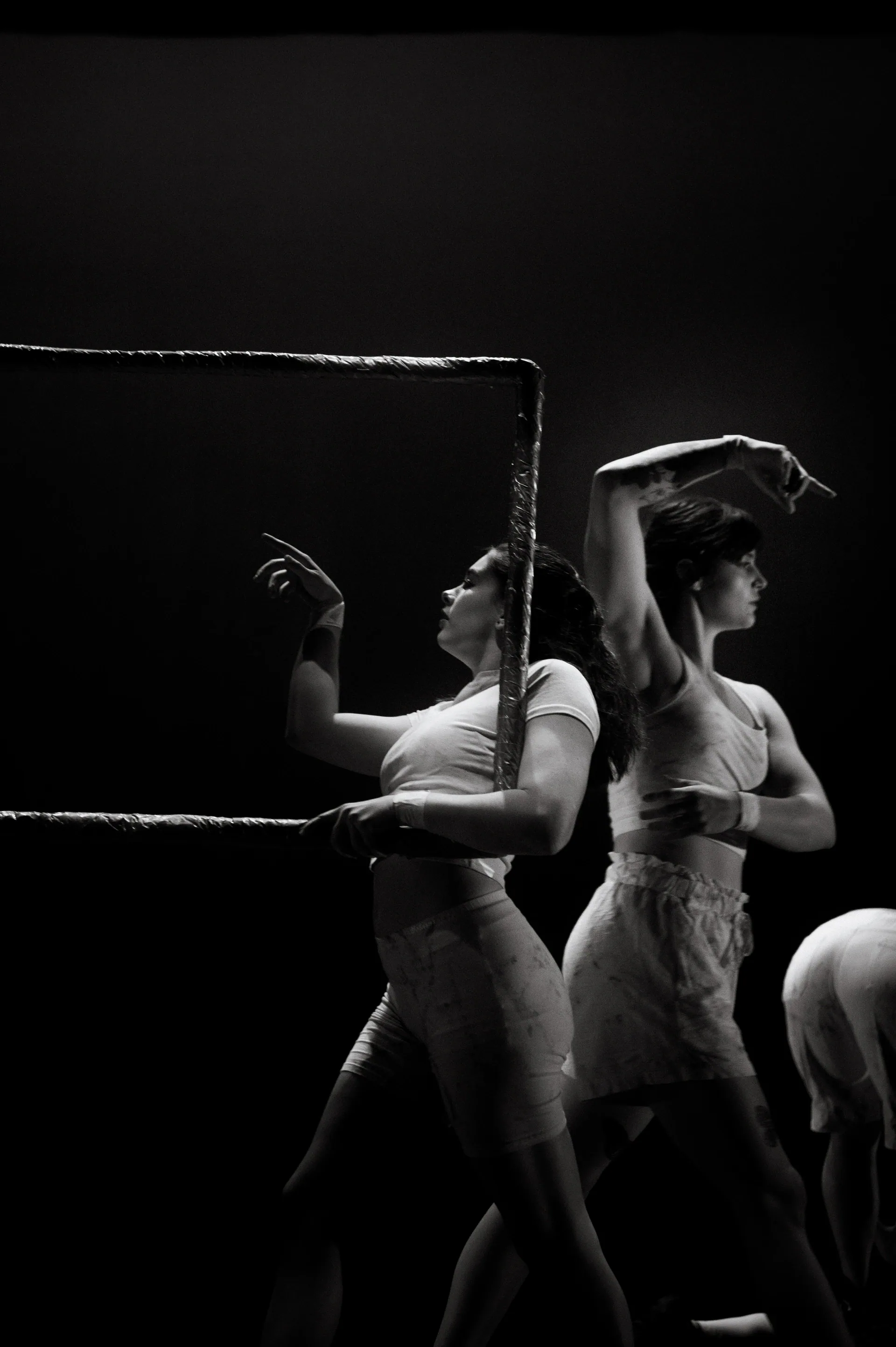 Dancers pose within and around a rectangular frame.