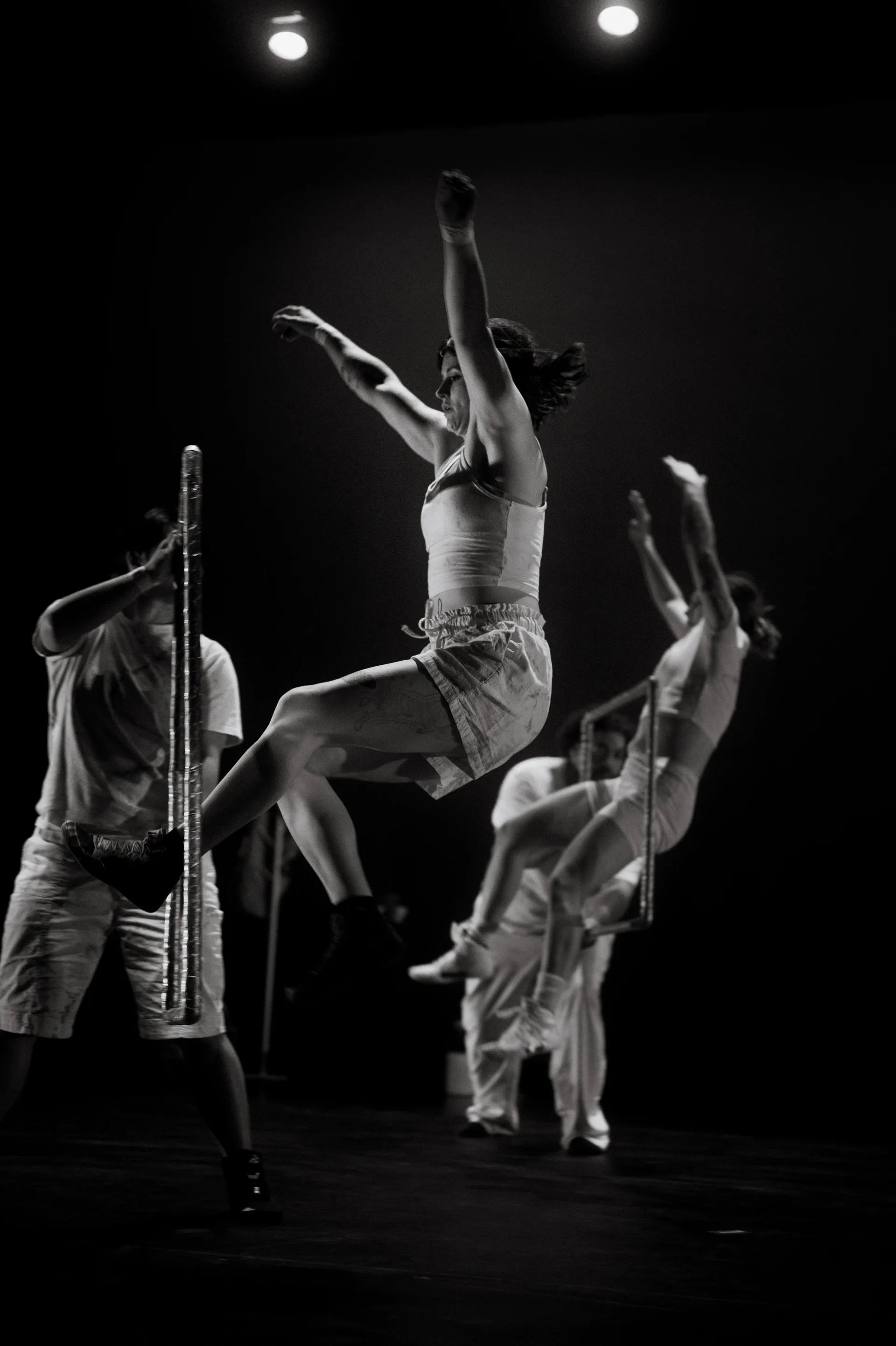 Group supports an upside-down performer at center stage.